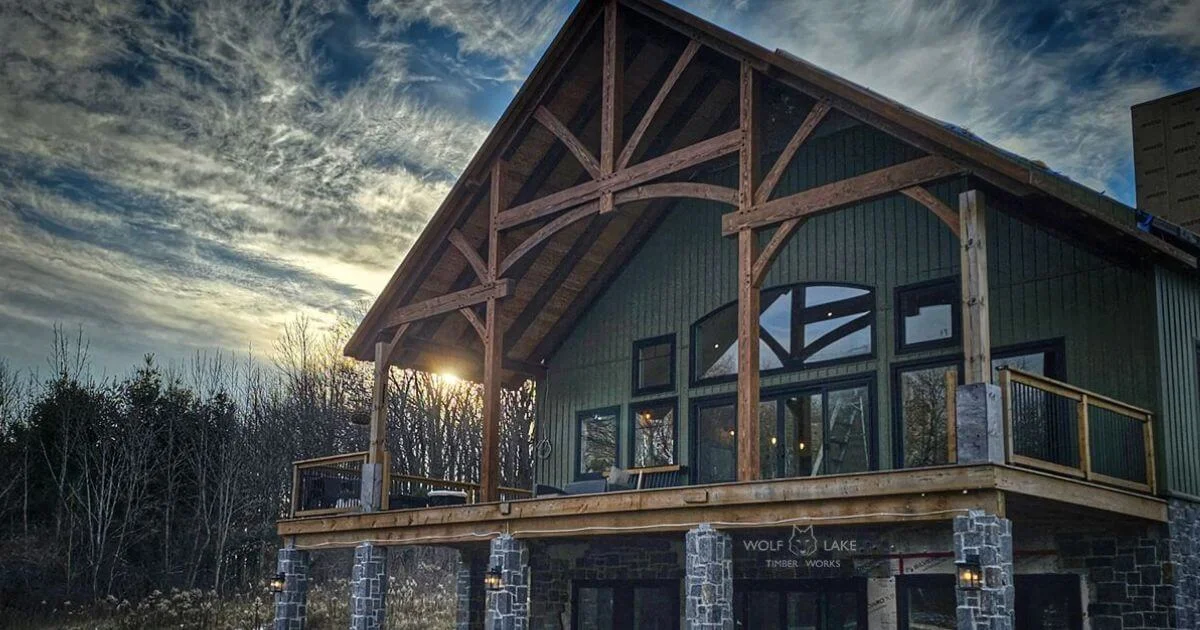 Timber frame cottage with exposed beams at sunset.